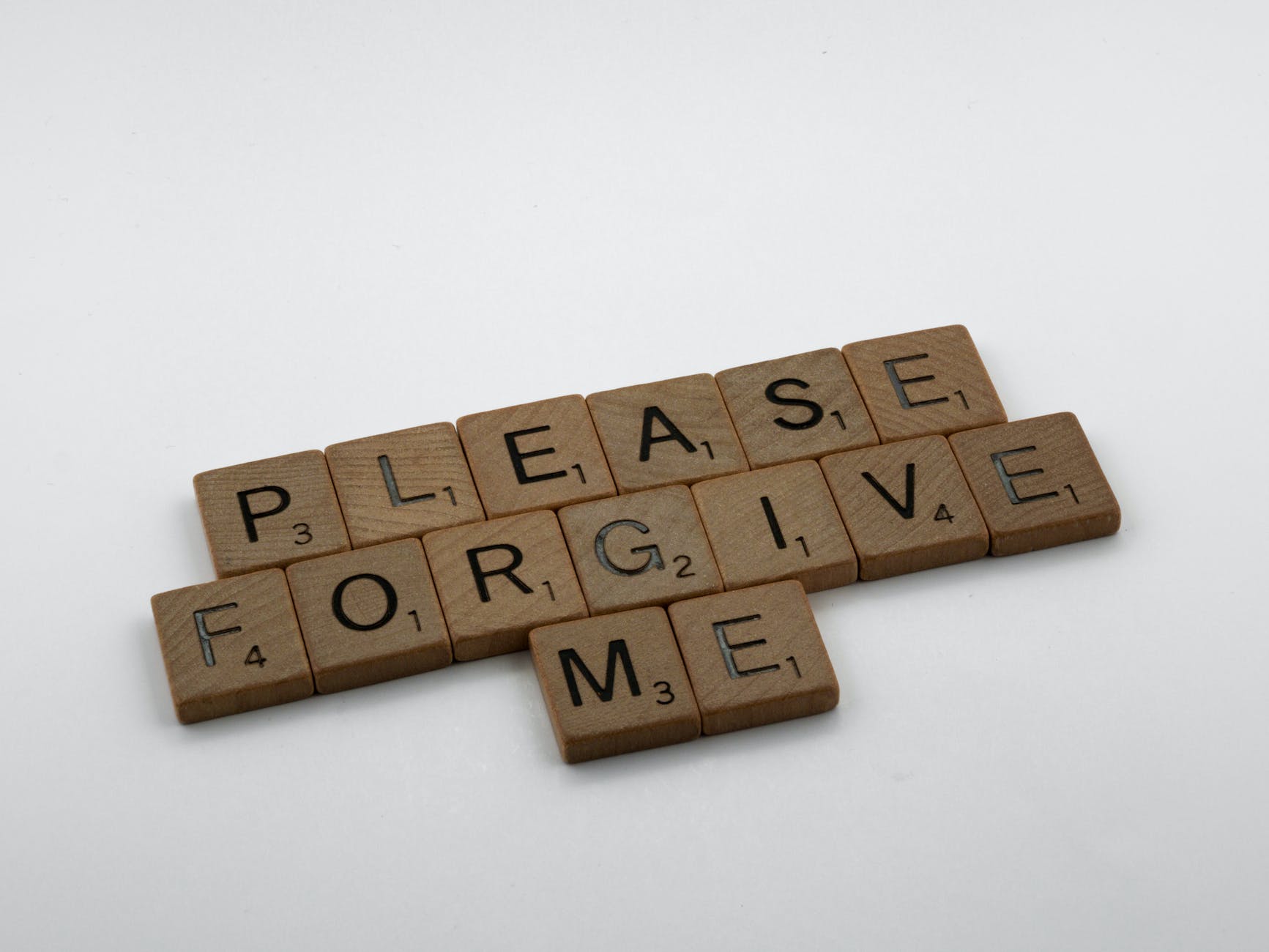 close up shot of scrabble tiles on a white surface