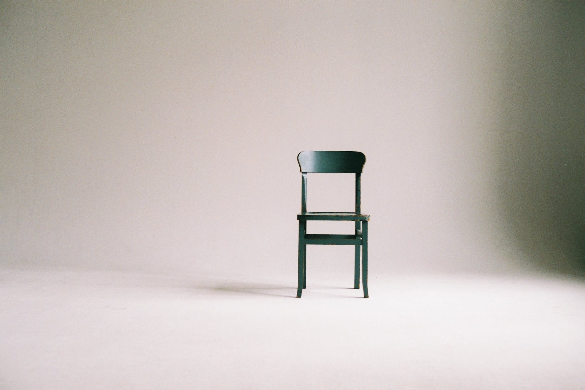 wooden chair on a white wall studio